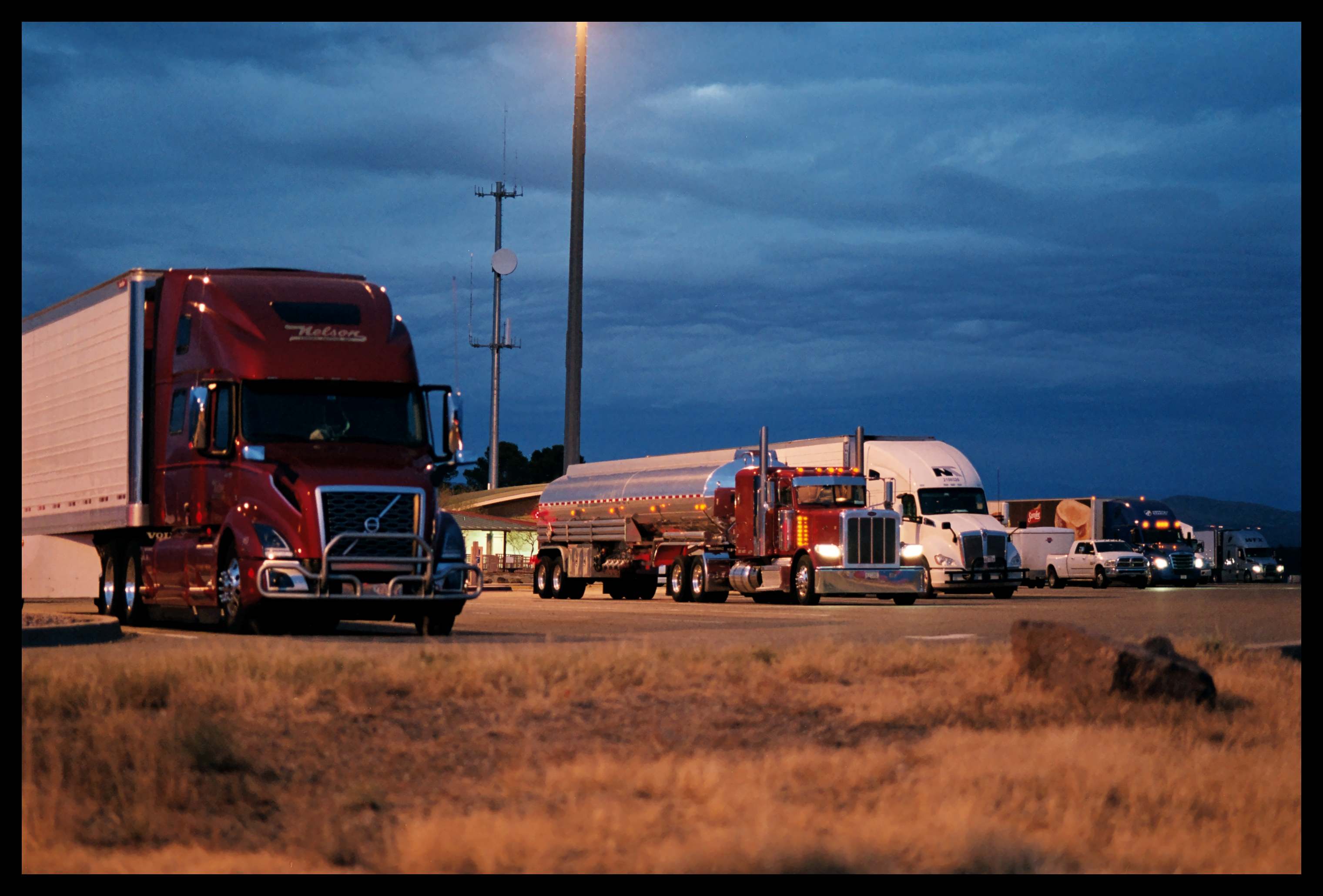 Photo of some trucks after sunset